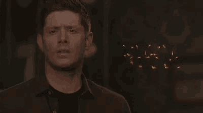 a man is standing in front of a sign that says jensen acklis