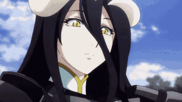 a girl with long black hair and horns on her head is looking at the camera .