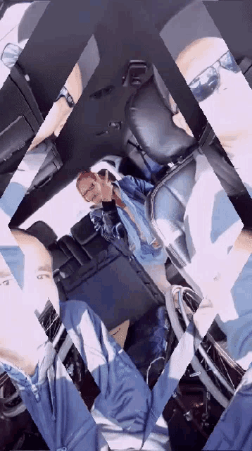 a man in a blue jacket is sitting in a car