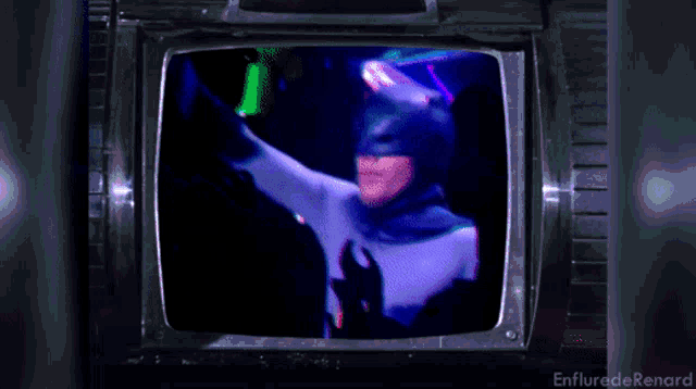 a picture of a man in a batman costume is displayed on a television screen