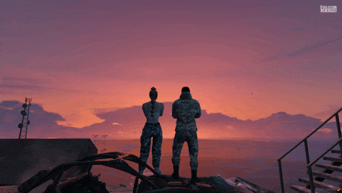 a man and a woman in military uniforms are standing on a rock overlooking the ocean