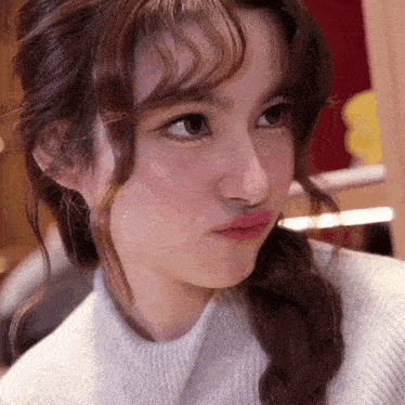 a close up of a girl making a funny face with her mouth open .