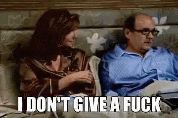 a man and a woman are sitting on a couch and the man is saying `` i do n't give a fuck ''