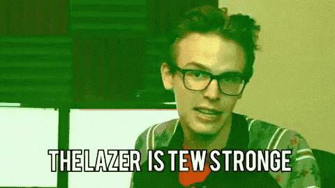 a young man wearing glasses is making a funny face and says the lazer is few stronge .