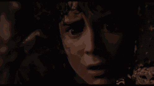 a close up of a person 's face with a blurred background .
