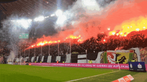 a soccer field with a banner that says " grai w gierki w aplikac "