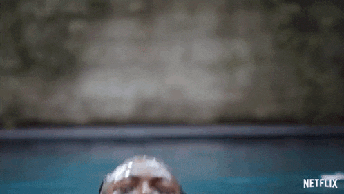 a close up of a woman 's face with water coming out of her mouth and neck .