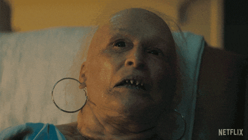 a woman with a bald head is laying in a hospital bed with a netflix logo in the background
