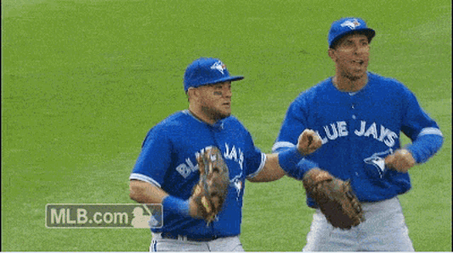 two blue jays baseball players on a field