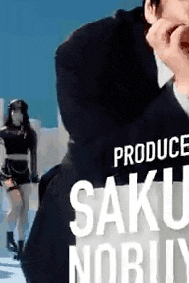 a man in a suit is holding a sign that says produce saku nobuy