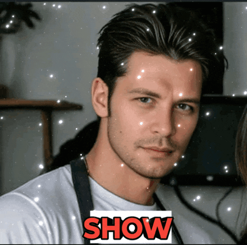 a man in a white shirt with the word show in red letters