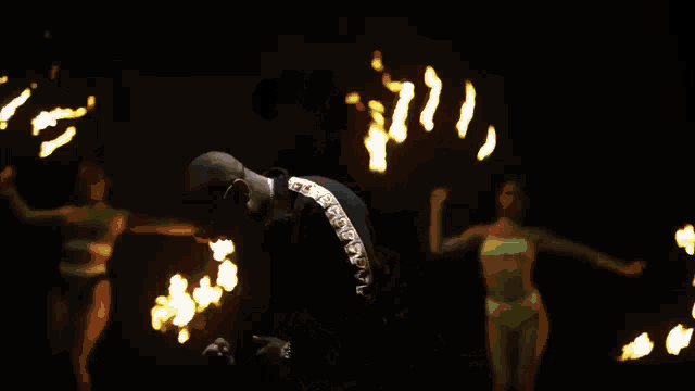 a man and woman are dancing in a dark room while holding sparklers .