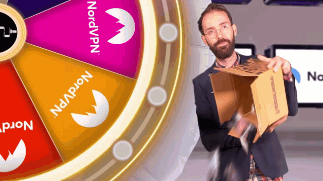 a man is holding a box in front of a spinning wheel that says nordvpn on it