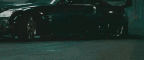 a car is driving down a street at night in a foggy area .