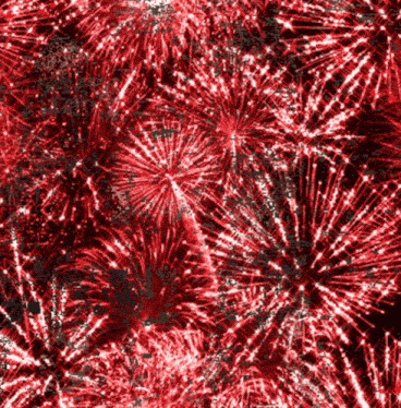 a bunch of red fireworks on a black background .