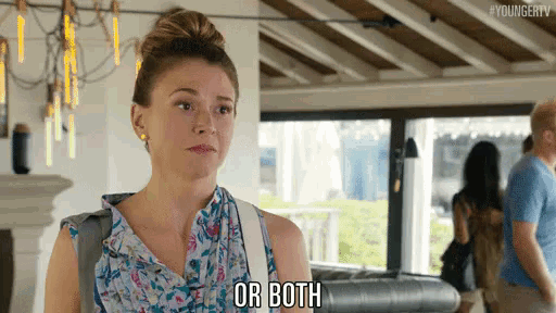 a woman is standing in a room and saying or both