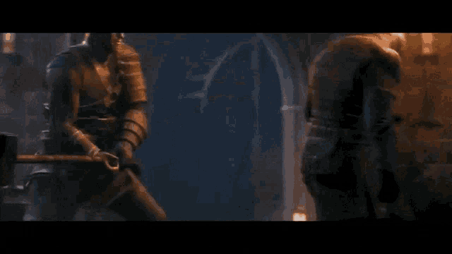 a blurred image of a man holding a sword