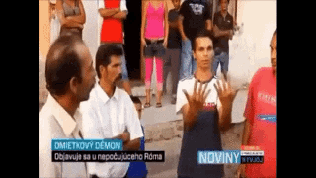 a group of people are standing in front of a screen that says noviny