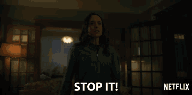 a woman is holding her head and says stop it