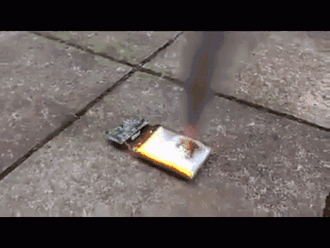 a lighter is laying on the ground with a flame coming out of it