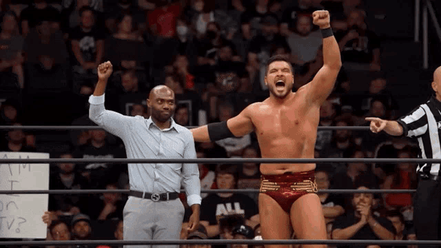 a man in a wrestling ring with a sign that says all