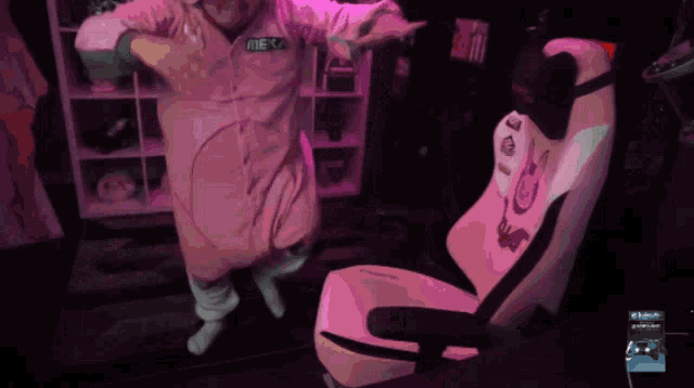 a person wearing a pink jumpsuit with the word meka on it
