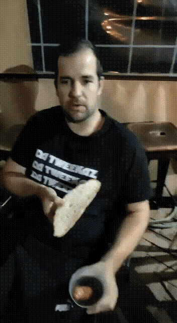 a man wearing a t-shirt that says " i 'm a freak "