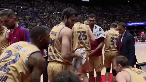 a group of basketball players including number 23 and 31 are huddled together