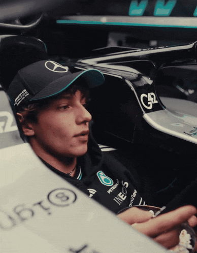 a man wearing a hat that says petronas on it