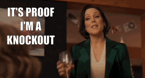 a woman is holding a glass of wine and says it 's proof i 'm a knockout ..