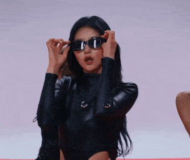 a woman wearing sunglasses and a black top