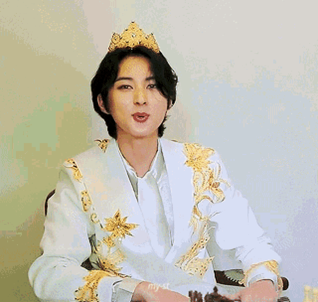 a man wearing a crown is pointing a gun