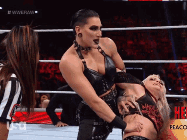 a woman is wrestling another woman in a ring with peaco on the bottom