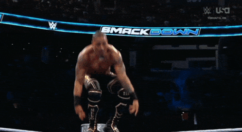 a wrestler is jumping over another wrestler in the ring