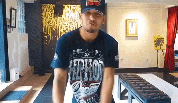 a man wearing a hat and a shirt that says ' hiphop ' on it