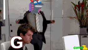 a man in a suit and tie is sitting in front of a computer with the letter g in the foreground