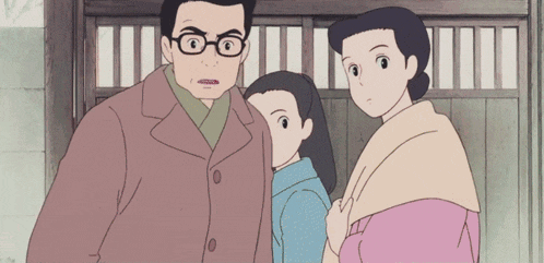 a man with glasses is standing next to a woman and a girl