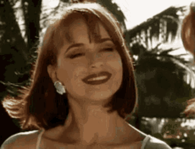 a close up of a woman 's face with a smile on her face .
