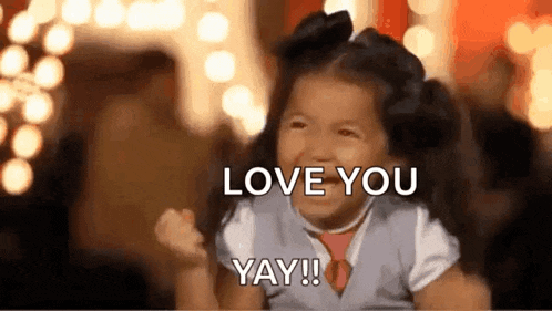 a little girl is making a funny face and saying `` love you yay '' .