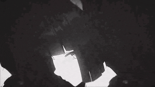 a black and white photo of a person standing in front of a building .