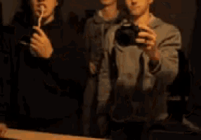 a blurry picture of two men taking a selfie