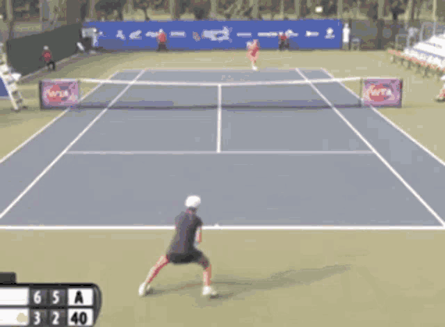 a tennis game is being played on a court with wta advertisements
