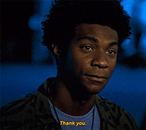 a man with a blue shirt that says thank you on it