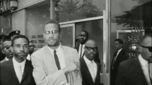 a group of men standing in front of a building that says civil specs