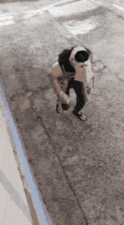 a person is walking down a sidewalk with a backpack on their back