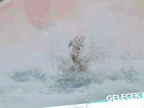 a woman in a bathing suit is swimming in a pool with the word gelecek written on the bottom