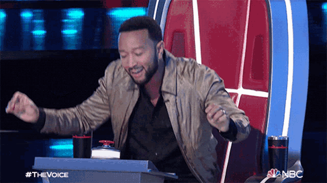 a man sitting in a chair with a nbc logo on the bottom right