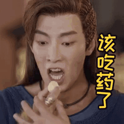 a man with long hair is eating something with chinese writing on his face