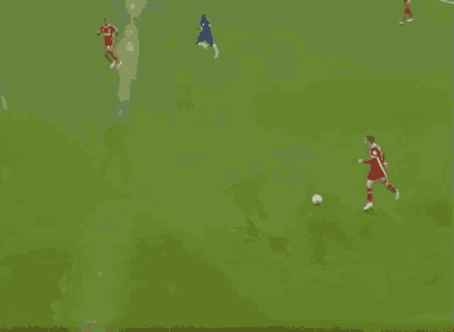 a group of soccer players are playing a game of soccer on a soccer field .