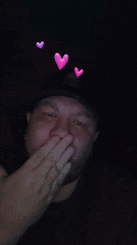 a man with a pink heart on his head